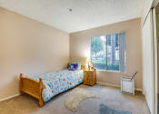 Thumbnail 17 of 29 - a bedroom with a bed and a window
