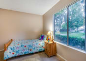 Thumbnail 20 of 29 - a bedroom with a bed and a large window