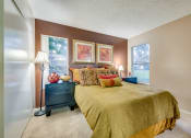 Thumbnail 16 of 29 - a bedroom with brown walls and a yellow bedspread