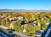 Thumbnail 8 of 29 - a neighborhood of houses with trees and mountains in the background