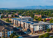 Thumbnail 4 of 24 - A bird's eye view of a residential area with houses and apartment buildings.
