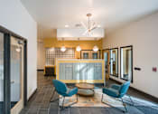 Thumbnail 11 of 19 - A modern office lobby with a reception desk and two chairs.
