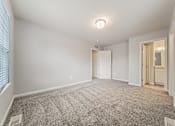 Thumbnail 7 of 36 - Townhome upstairs bedroom, carpeted, with attached bathroom.