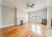 Thumbnail 23 of 39 - Living room with a fireplace and wood flooring at Integrity Gold Coast Apartments, Cleveland, Ohio