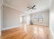 Thumbnail 24 of 39 - Dining room with hardwood floors and a ceiling fan. at Integrity Gold Coast Apartments, Ohio