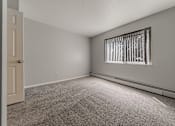 Thumbnail 40 of 49 - A room with a carpeted floor and a window with bars on it. at Integrity Berea Apartments, Berea, 44017