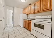 Thumbnail 38 of 49 - A kitchen with white appliances and wooden cabinets. at Integrity Berea Apartments, Ohio, 44017