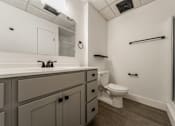 Thumbnail 27 of 29 - A bathroom with a toilet, sink, and a towel bar.