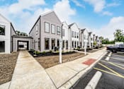 Thumbnail 5 of 18 - A row of modern houses with a truck parked in the driveway at Westwood Meadows, Westlake, OH, 44145