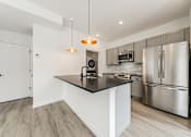 Thumbnail 1 of 18 - A modern kitchen with stainless steel appliances and a central island at Westwood Meadows, Westlake, OH, 44145