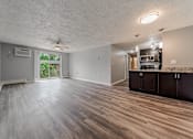 Thumbnail 6 of 49 - A spacious room with wood flooring and a ceiling fan. at Integrity Berea Apartments, Berea, Ohio