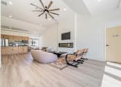 Thumbnail 29 of 39 - A modern living room with a brown ceiling fan and lighting.