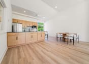 Thumbnail 33 of 39 - A kitchen with wooden floors and cabinets.