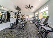 Thumbnail 36 of 39 - A spacious home gym with a variety of exercise equipment.