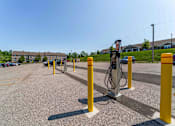 Thumbnail 31 of 39 - A parking lot with a charging station for electric vehicles.