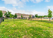 Thumbnail 24 of 39 - Grassy dog park at Renova of Brunswick Apartments, Brunswick