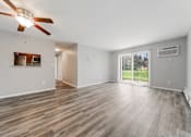 Thumbnail 6 of 21 - Living room with a ceiling fan and wood flooring at Integrity Chardon Apartments, Chardon,  Ohio