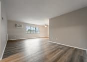 Thumbnail 26 of 32 - A room with wooden flooring and a window with blinds.