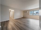 Thumbnail 8 of 32 - A room with wooden flooring and a window with blinds.