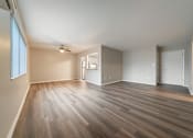 Thumbnail 7 of 32 - A room with wooden flooring and a ceiling fan.