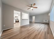 Thumbnail 6 of 32 - A room with a ceiling fan and wooden flooring.