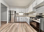 Thumbnail 5 of 32 - A kitchen with a stainless steel refrigerator, dishwasher, and oven.