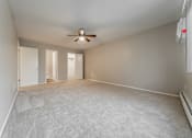Thumbnail 11 of 32 - Empty room with a ceiling fan and carpeted floor.