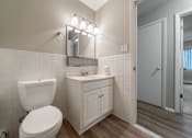 Thumbnail 15 of 32 - A white toilet sits next to a sink in a bathroom.