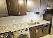 Thumbnail 44 of 49 - A kitchen with a black refrigerator and a sink. at Integrity Berea Apartments, Berea, 44017