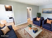 Thumbnail 30 of 49 - A living room with a blue couch and a coffee table. at Integrity Berea Apartments, Berea, Ohio