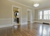 Thumbnail 12 of 39 - Dining room with hardwood floors and a large window. at Integrity Gold Coast Apartments, Cleveland, 44102