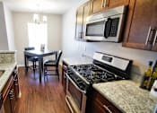 Thumbnail 12 of 36 - Townhome dining and kitchen area featuring dark cherry wood.