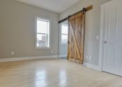 Thumbnail 5 of 39 - A room with a sliding barn door and a window. at Integrity Gold Coast Apartments, Cleveland, Ohio