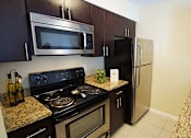 Thumbnail 21 of 36 - Renovated apartment kitchen with stainless steel appliances.