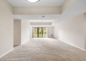 Thumbnail 22 of 42 - A spacious living room with sliding glass doors to a balcony.at Atrium in The Village, Beachwood Ohio