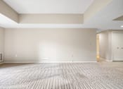 Thumbnail 21 of 42 - A large empty room with a carpeted floor and white walls.at Atrium in The Village, Ohio, 44122