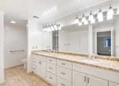 Thumbnail 35 of 42 - A bathroom with a marble countertop and a large mirror.at Atrium in The Village, Beachwood, OH
