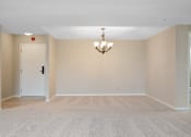 Thumbnail 17 of 42 - A dining room with a chandelier off of living room.at Atrium in The Village, Beachwood