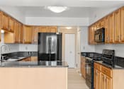 Thumbnail 12 of 42 - Kitchen with Maple Cabinets at Atrium in The Village, Beachwood, OH