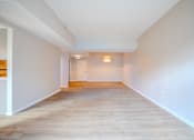 Thumbnail 16 of 42 - A long, empty hallway with light wood flooring and white walls t Atrium in The Village, Beachwood, OH 44122