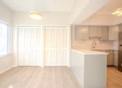 Thumbnail 6 of 42 - A kitchen with a white island and wooden floors t Atrium in The Village, 44122