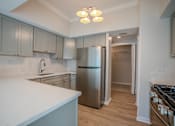 Thumbnail 5 of 42 - A kitchen with a refrigerator, stove, and cabinets t Atrium in The Village, Beachwood