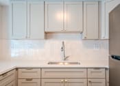 Thumbnail 3 of 42 - A kitchen with white cabinets and a stainless steel refrigerator t Atrium in The Village, Beachwood, OH 44122
