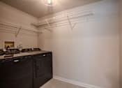 Thumbnail 38 of 42 - A kitchen with white walls and a black counter top t Atrium in The Village, Beachwood, Ohio
