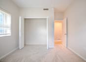 Thumbnail 29 of 42 - A white room with a carpeted floor and a window with blinds t Atrium in The Village, Beachwood, OH 