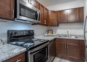Thumbnail 5 of 13 - Dark finish upgraded kitchen at Eagles Landing Apartments, Integrity Realty, Kent, 44240