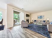 Thumbnail 3 of 46 - Updated living room with plank-style flooring and example furnishings at Hunt Club Apartments, Copley