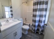 Thumbnail 17 of 18 - a bathroom with a sink toilet and shower