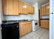 Thumbnail 36 of 37 - Kitchen with maple cabinets and tile floors at Integrity Cleveland Heights, Cleveland Heights, Ohio, 44106