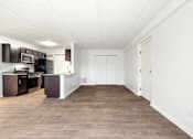 Thumbnail 4 of 22 - A kitchen with dark brown cabinets and white walls at Integrity Medina Apartments, Medina, OH,  44256